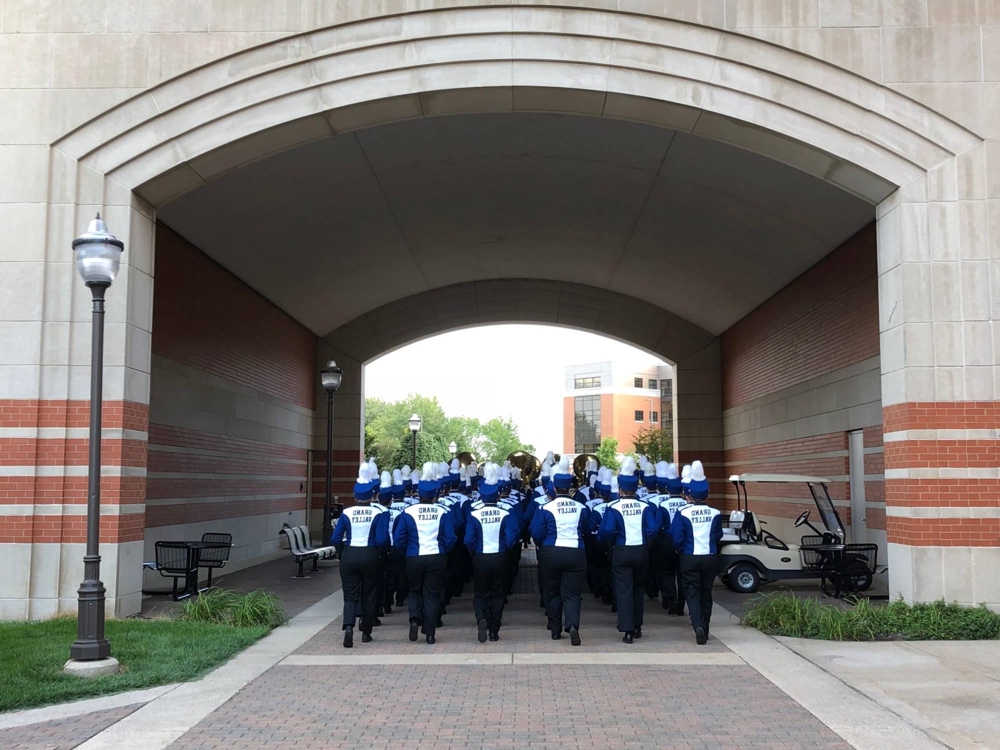 LMB marching under an archway